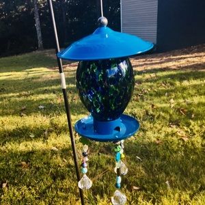 Blue glass bird feeder with hanging beads